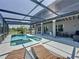 Relaxing screened-in pool area with lounge chairs, outdoor grill, and well-maintained patio, perfect for entertaining at 805 Suffolk Pl, Davenport, FL 33896