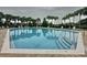 Refreshing community swimming pool surrounded by lush landscaping and lounge chairs at 805 Suffolk Pl, Davenport, FL 33896