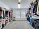 Large walk-in closet with built-in shelving, carpeted floor and storage for an organized wardrobe at 805 Suffolk Pl, Davenport, FL 33896