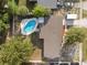 Aerial view of a home with a pool, fenced yard, and mature trees at 807 E Airport Blvd, Sanford, FL 32773