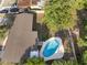 Aerial view of a home with a pristine backyard pool, surrounded by mature trees offering shade and privacy at 807 E Airport Blvd, Sanford, FL 32773