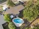 Aerial view of a house and backyard featuring an in-ground pool and mature trees at 807 E Airport Blvd, Sanford, FL 32773