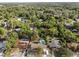 Aerial view of a home with backyard pool, nestled within a verdant, tree-filled community at 807 E Airport Blvd, Sanford, FL 32773