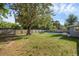 Spacious backyard featuring a large tree, fence, and in-ground pool at 807 E Airport Blvd, Sanford, FL 32773