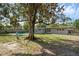 Large backyard with an in-ground pool and a mature shade tree at 807 E Airport Blvd, Sanford, FL 32773