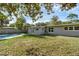 Well-maintained backyard with an in-ground pool and a covered patio at 807 E Airport Blvd, Sanford, FL 32773