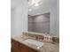 Updated bathroom features granite counters and a large vanity with a decorative mirror at 807 E Airport Blvd, Sanford, FL 32773
