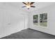 Bedroom with wood-look floors, a ceiling fan, a large window, and a closet at 807 E Airport Blvd, Sanford, FL 32773