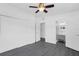This bedroom features wood-look floors, a ceiling fan, and an ensuite bathroom at 807 E Airport Blvd, Sanford, FL 32773