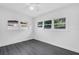 Bright bedroom featuring gray laminate flooring, and three windows for natural light at 807 E Airport Blvd, Sanford, FL 32773