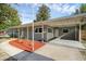 Charming single-story home featuring a covered carport, manicured landscaping, and a freshly painted facade at 807 E Airport Blvd, Sanford, FL 32773