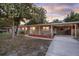 Single-story home with front yard, carport, decorative lighting, and tidy landscaping, perfect for curb appeal at 807 E Airport Blvd, Sanford, FL 32773