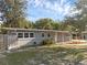 Charming single story home with welcoming front porch and a well-maintained yard under a clear sky at 807 E Airport Blvd, Sanford, FL 32773