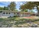 Charming single story home with welcoming front porch and a well-maintained yard under a clear sky at 807 E Airport Blvd, Sanford, FL 32773
