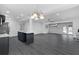 Open concept kitchen featuring an island, stainless appliances, and seamless flow into the large living area at 807 E Airport Blvd, Sanford, FL 32773