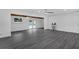 Spacious living room with light gray flooring, wood beam ceiling detail, and french doors to pool at 807 E Airport Blvd, Sanford, FL 32773