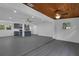 Open-concept living room with a kitchen, ceiling fans, and wood ceiling at 807 E Airport Blvd, Sanford, FL 32773