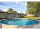 Backyard pool featuring clear blue water, light patio, and partial home view at 807 E Airport Blvd, Sanford, FL 32773