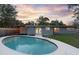 Backyard features a private pool, home exterior, string lights, and a stunning sunset at 807 E Airport Blvd, Sanford, FL 32773