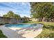Features a private backyard pool surrounded by well-kept landscaping and partial home view at 807 E Airport Blvd, Sanford, FL 32773