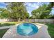 Backyard with a private in-ground pool surrounded by a concrete patio and a well-maintained lawn at 807 E Airport Blvd, Sanford, FL 32773