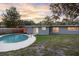 The backyard showcases a private pool, exterior home view, and beautiful sunset at 807 E Airport Blvd, Sanford, FL 32773