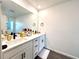 Bright bathroom featuring double sinks, modern fixtures, and ample counter space at 921 Spring Palms Loop, Orlando, FL 32828