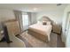 A cozy bedroom features a beautifully adorned bed, dresser, and window for natural light at 921 Spring Palms Loop, Orlando, FL 32828