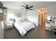 Bright bedroom with a ceiling fan, accent wall art and a vanity area for added comfort at 921 Spring Palms Loop, Orlando, FL 32828