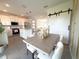 Stylish dining area adjacent to a kitchen featuring a large island and barndoor accent wall at 921 Spring Palms Loop, Orlando, FL 32828