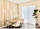 Elegant dining room with a wooden table, stylish chairs, and modern window blinds at 921 Spring Palms Loop, Orlando, FL 32828