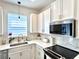 Bright kitchen with white cabinets, stylish lighting, and stainless steel appliances at 921 Spring Palms Loop, Orlando, FL 32828