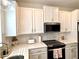 Well-appointed kitchen featuring white cabinets, modern appliances, and marble accents at 921 Spring Palms Loop, Orlando, FL 32828