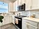 Well-lit kitchen with white cabinets, stainless steel appliances, and a contemporary design at 921 Spring Palms Loop, Orlando, FL 32828