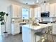 Bright kitchen featuring white cabinetry, stainless steel appliances, and a stylish island with seating at 921 Spring Palms Loop, Orlando, FL 32828