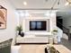 Bright living room offers a modern entertainment center, plush sofa, round coffee table, and stylish decor at 921 Spring Palms Loop, Orlando, FL 32828