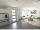 Open-concept area that includes a modern kitchen and living space decorated with neutral colors and modern decor at 921 Spring Palms Loop, Orlando, FL 32828