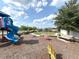 Community playground with slides, rocking horses, benches and picnic tables in a grassy, tree-lined area at 921 Spring Palms Loop, Orlando, FL 32828