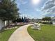 Colorful community playground featuring benches, picnic table, a climbing structure, and a winding walkway at 921 Spring Palms Loop, Orlando, FL 32828