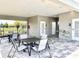 Seating area adjacent to pool house with tables, chairs, drinking fountain and access to restrooms at 921 Spring Palms Loop, Orlando, FL 32828
