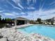 Inviting community pool with a covered seating area, perfect for relaxing on sunny days at 921 Spring Palms Loop, Orlando, FL 32828