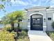 Secured pool entrance showcases lush landscaping, a modern gate, and clear signage for residents at 921 Spring Palms Loop, Orlando, FL 32828