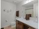 Bright bathroom offers a modern vanity with a sink, toilet, and neutral paint at 1139 Seedorf Dr, Winter Haven, FL 33881