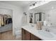 Bathroom features double vanity, modern lighting, walk-in closet, and glass shower at 1139 Seedorf Dr, Winter Haven, FL 33881