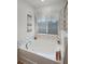 Bathroom features an oversized soaking tub with unique tile and natural light at 1139 Seedorf Dr, Winter Haven, FL 33881