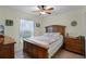 Cozy bedroom features ceiling fan, natural light, curtains, and hardwood floors at 1139 Seedorf Dr, Winter Haven, FL 33881