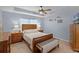 Comfortable bedroom features ceiling fan, tray ceiling, stylish lighting, and natural light at 1139 Seedorf Dr, Winter Haven, FL 33881