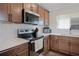 Well-lit kitchen features wood cabinets, stainless steel appliances, white backsplash, and stylish countertops at 1139 Seedorf Dr, Winter Haven, FL 33881