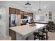 Modern kitchen with stainless steel appliances, island seating and stylish pendant lighting at 1139 Seedorf Dr, Winter Haven, FL 33881
