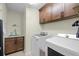 Well-equipped laundry room with modern washer, dryer, and cabinet storage at 1139 Seedorf Dr, Winter Haven, FL 33881